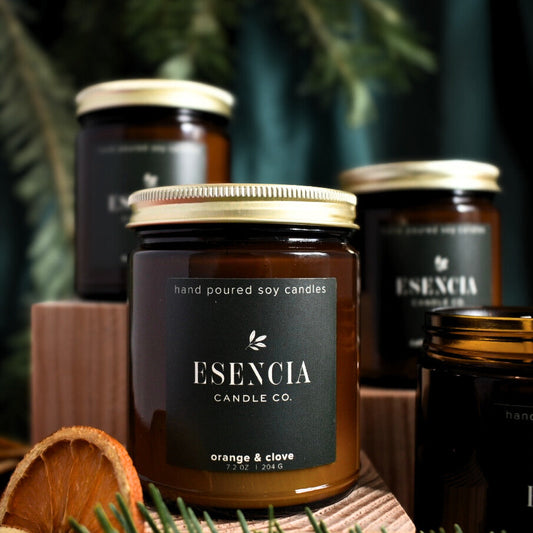 Esencia Candle Co. candles with decorative elements on a dark background
